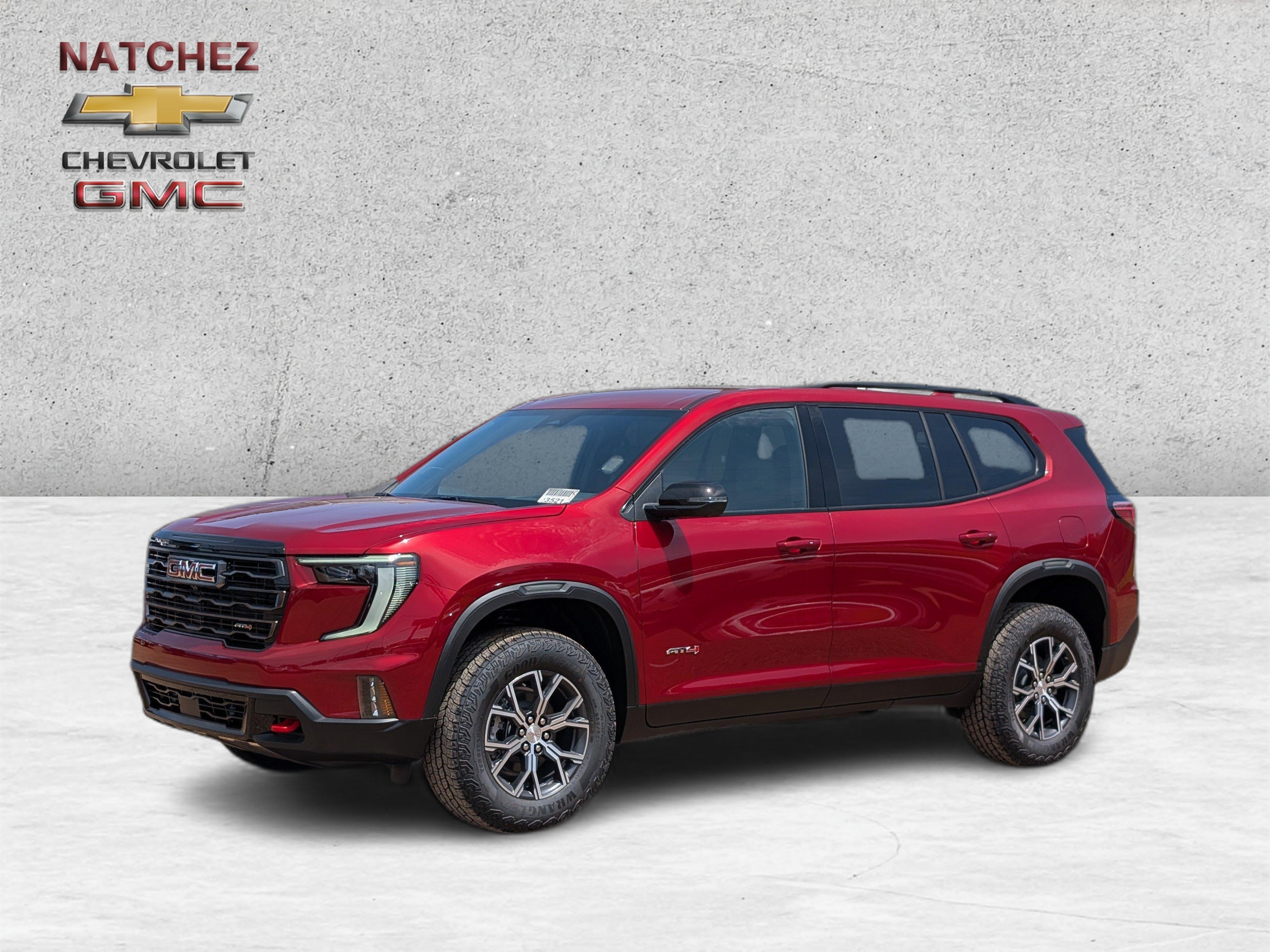 2026 GMC Acadia AT4 in Volcanic Red Tintcoat — front three-quarter view