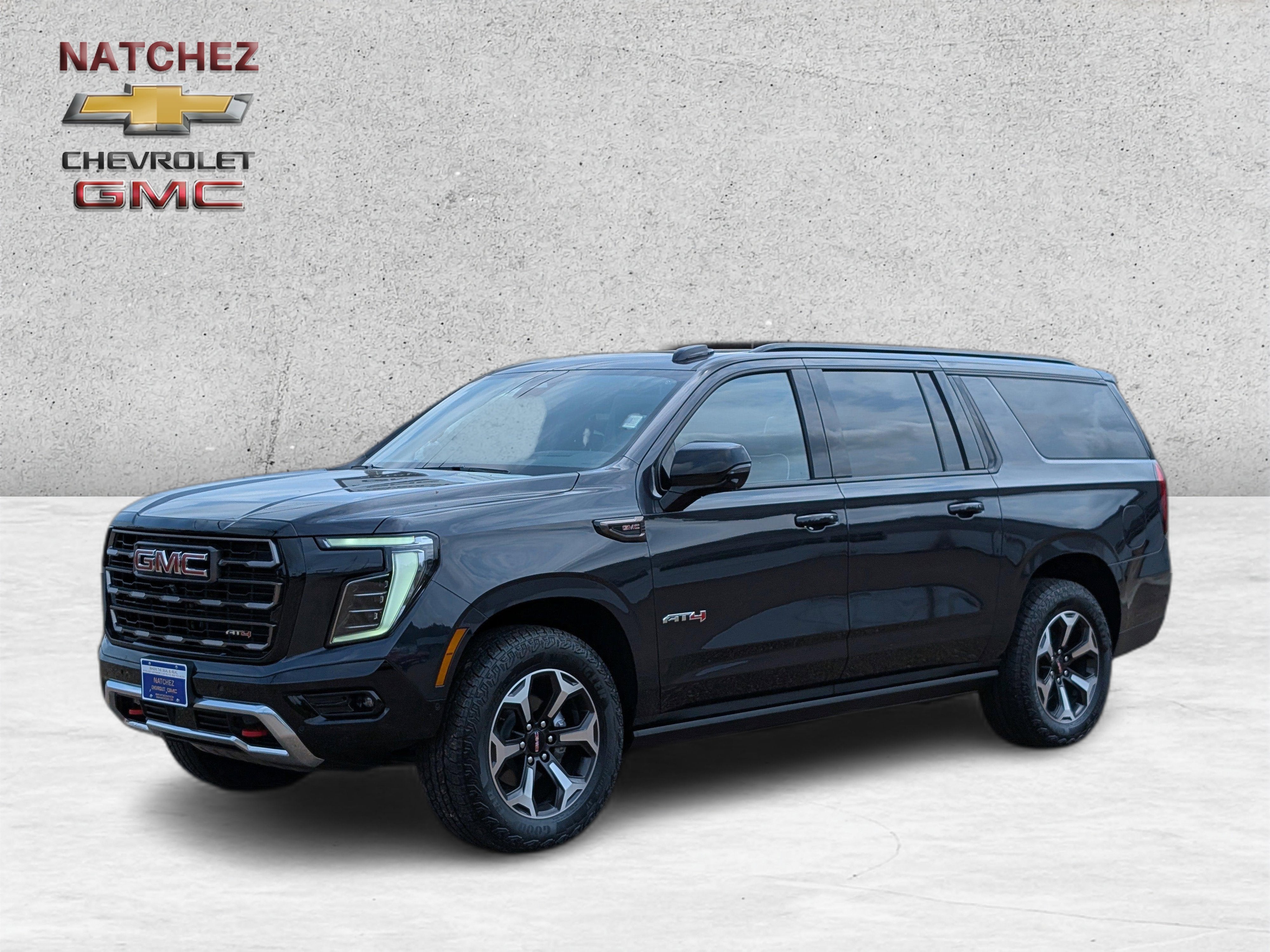 2026 GMC Yukon XL AT4 Ultimate in Titanium Rush Metallic — front three-quarter view
