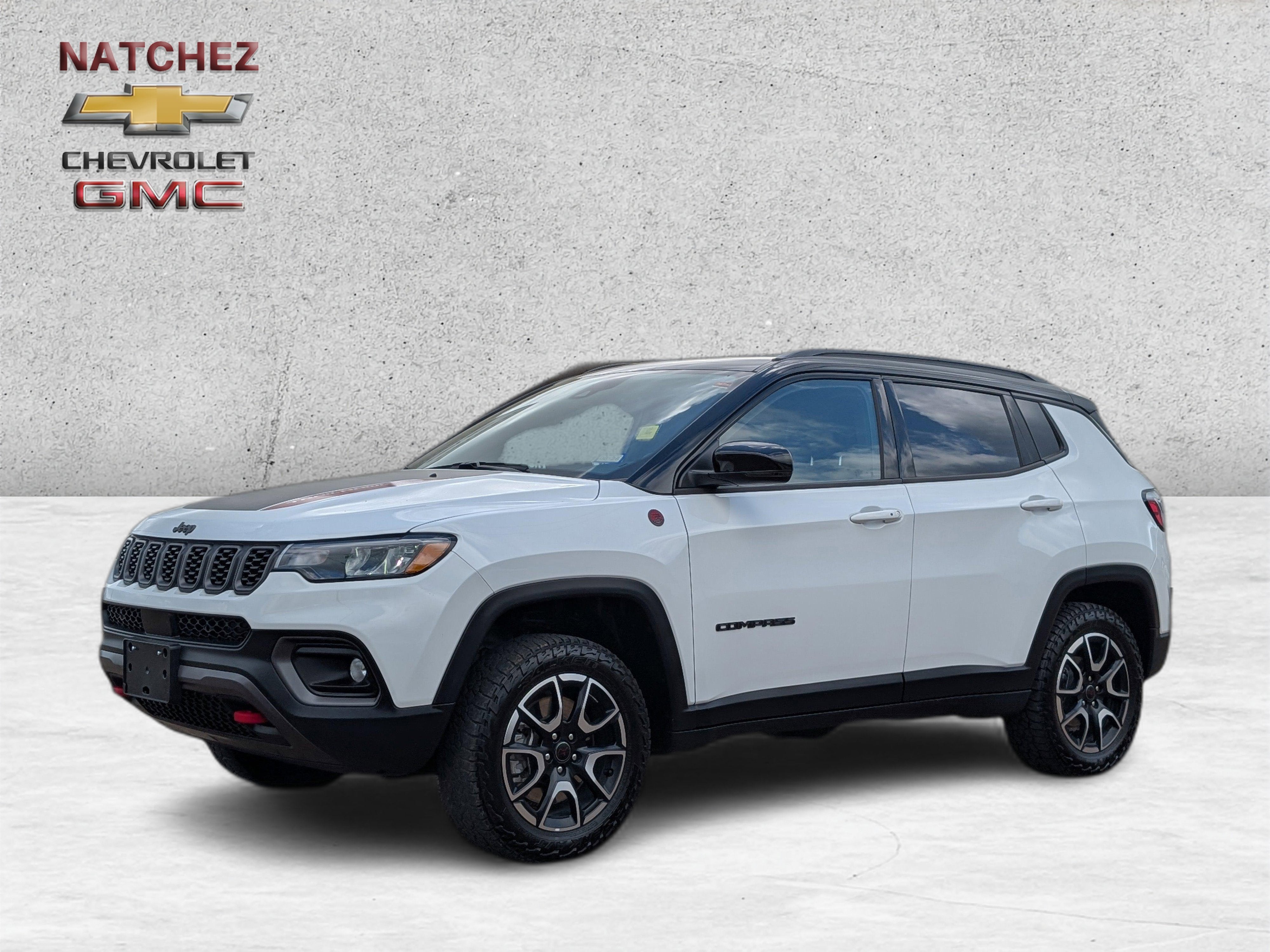 2025 Jeep Compass Trailhawk in White — front three-quarter view
